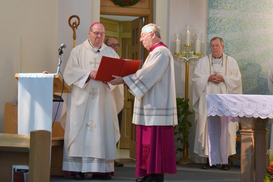 Bishop Deeley and Msgr. Marc Caron to his left