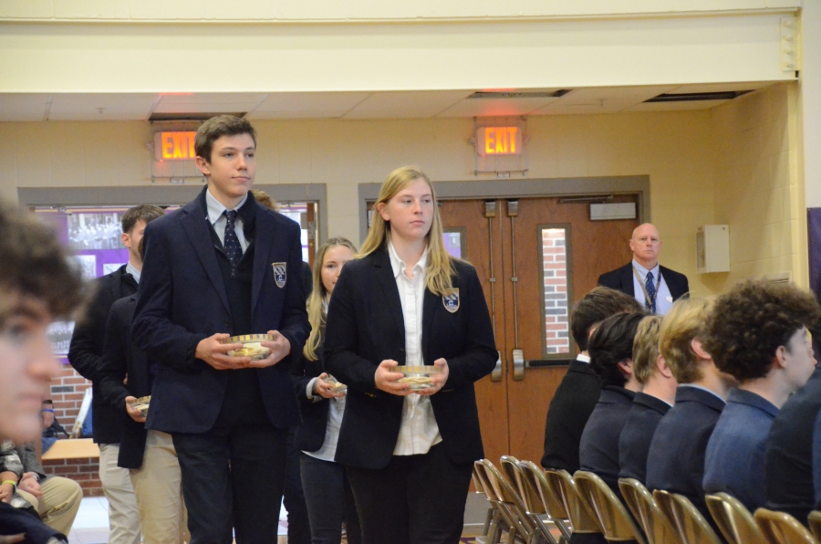 Two students walking in a gym