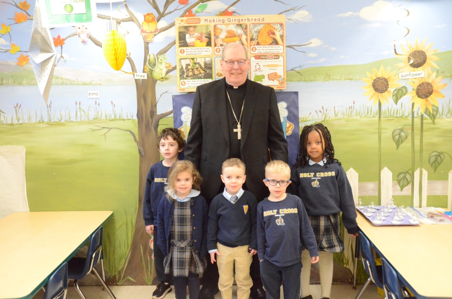 The bishop with five children in front of a nativity scene