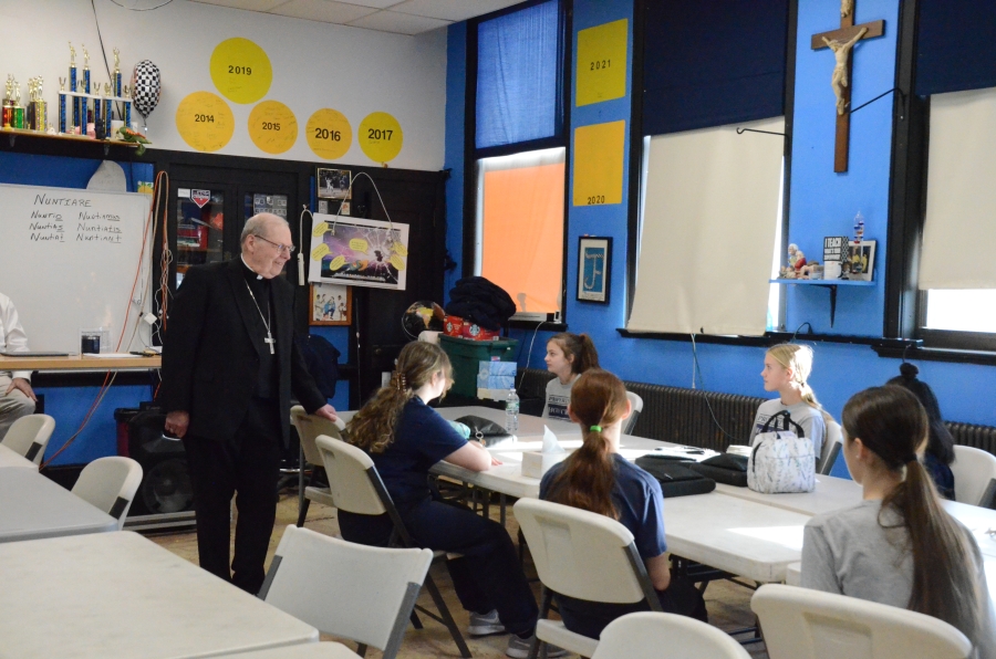 The bishop addresses seated students