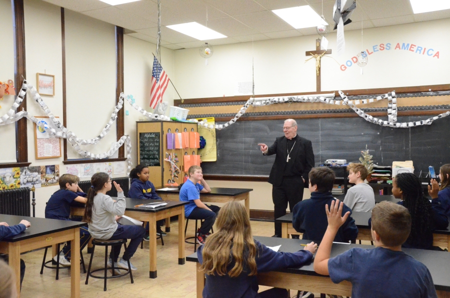 The bishop addresses a class of seated students 