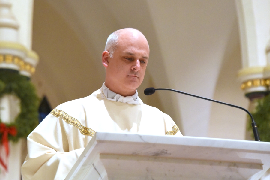 Father Seamus Griesbach reads the Gospel.