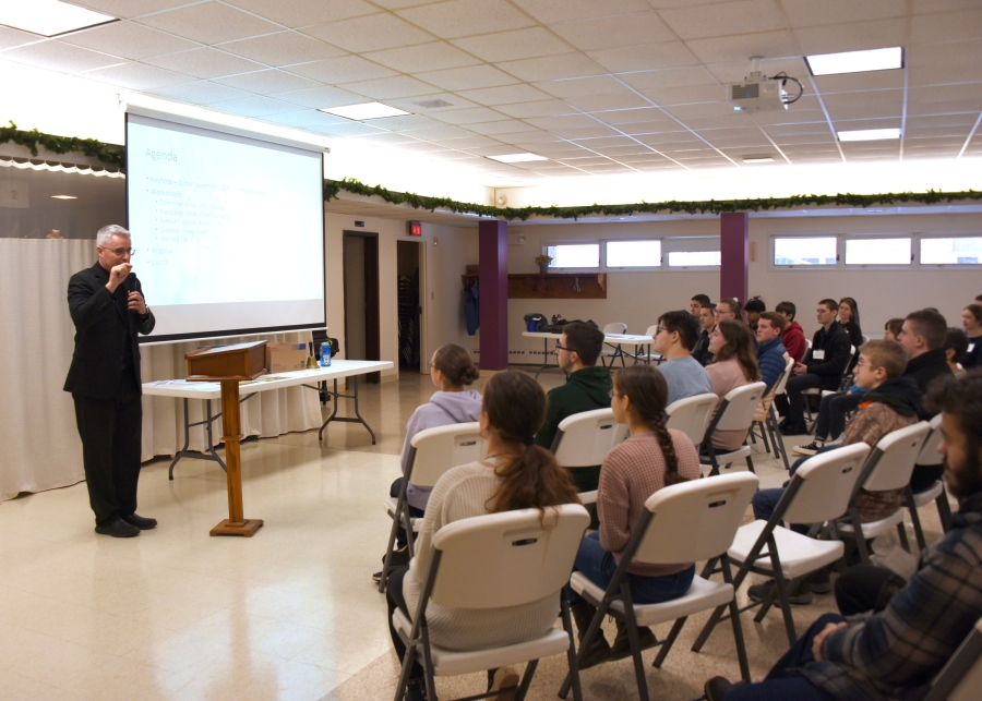 Teens listening to Deacon Luis Sanclemente.