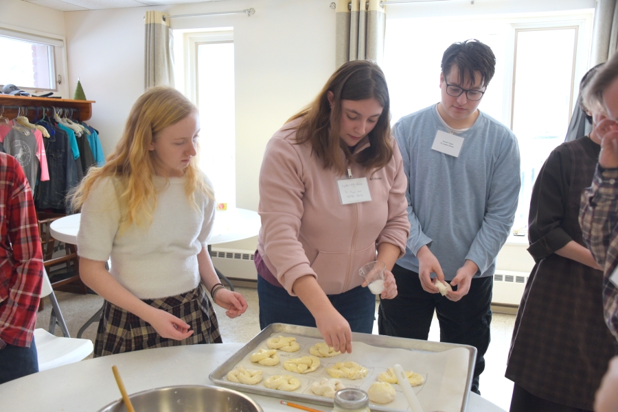 Teenagers make pretzels