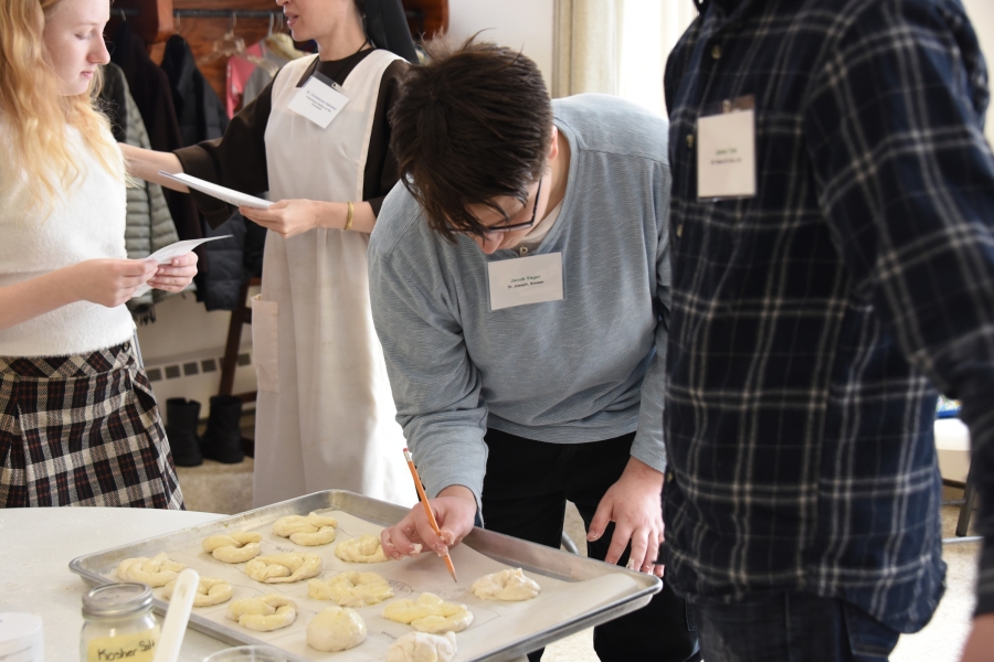 Teenagers make pretzels.