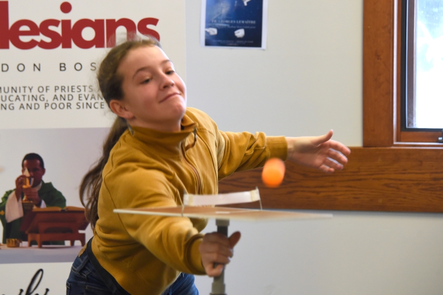 Teenaged girl  plays personal ping pong.