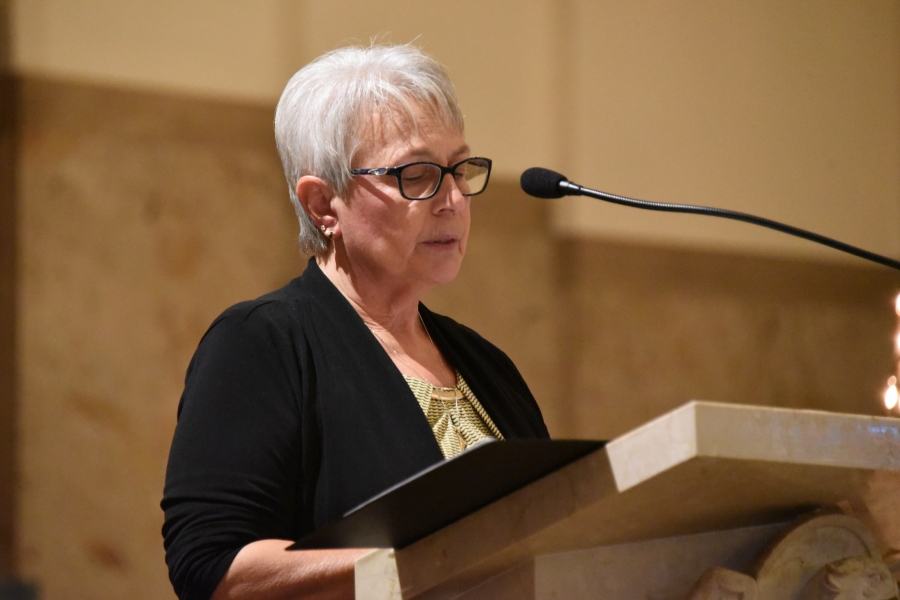 Doris Belanger reads the names of the victims.