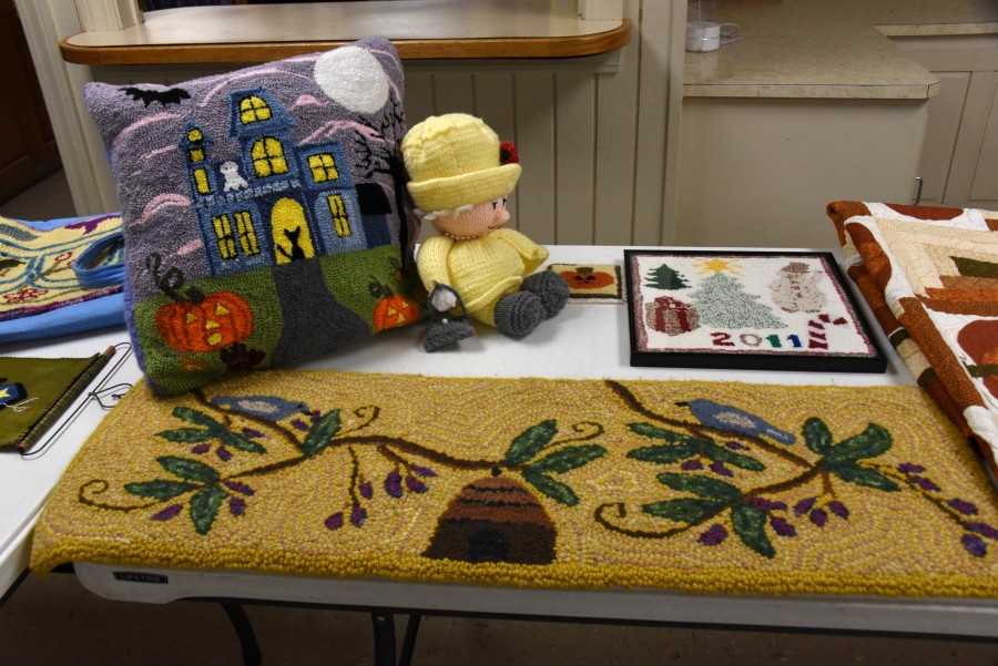A rug, a pillow, and a Queen Elizabeth doll