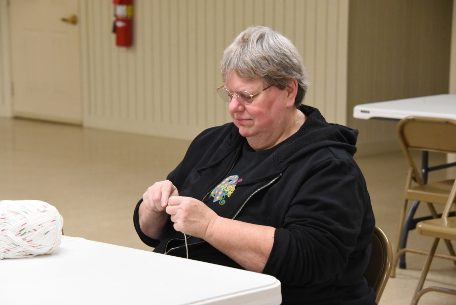 A woman crochets.