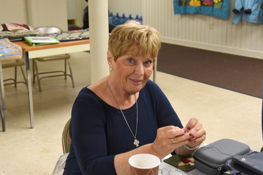 A woman crochets.