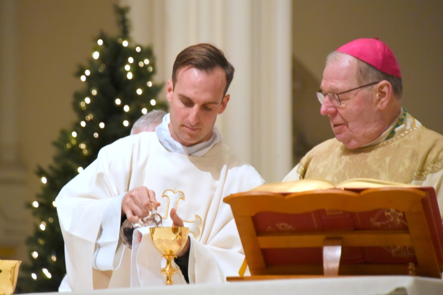 Deacon Matthew Valles assists Bishop Deeley at the altar.
