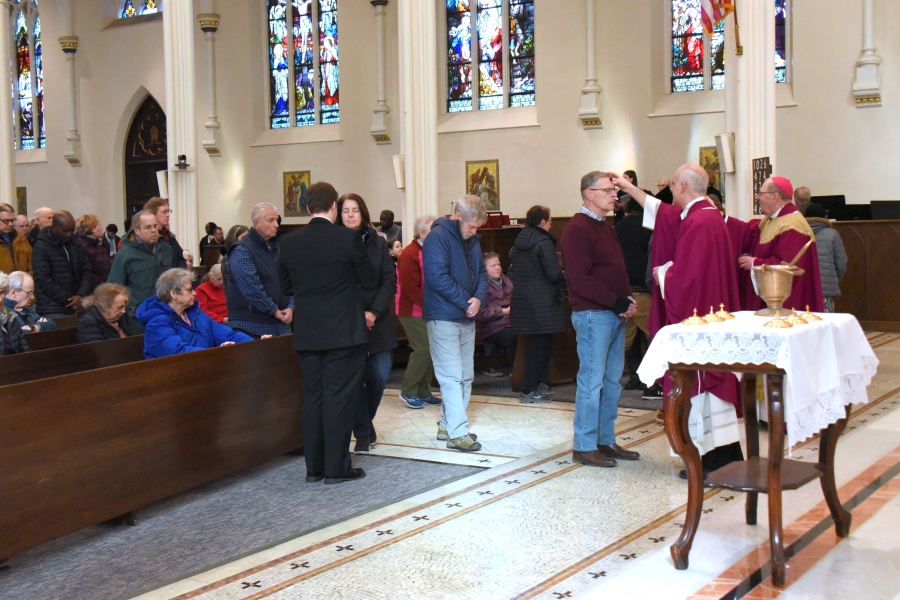 People line up to receive ashes.