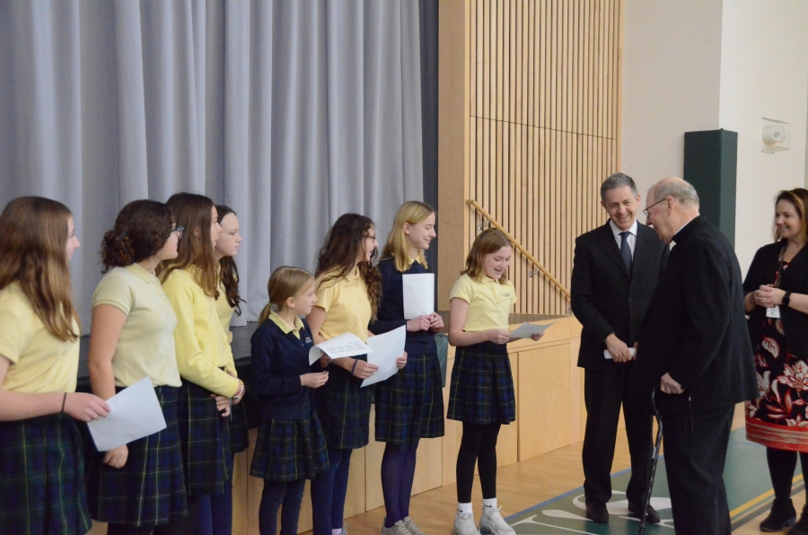 Students read to the bishop