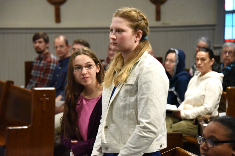 Two women standing at the Rite of Election in Presque Isle.