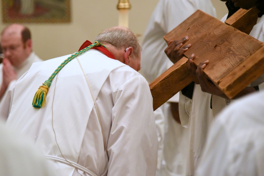 Bishop Deeley kisses the cross