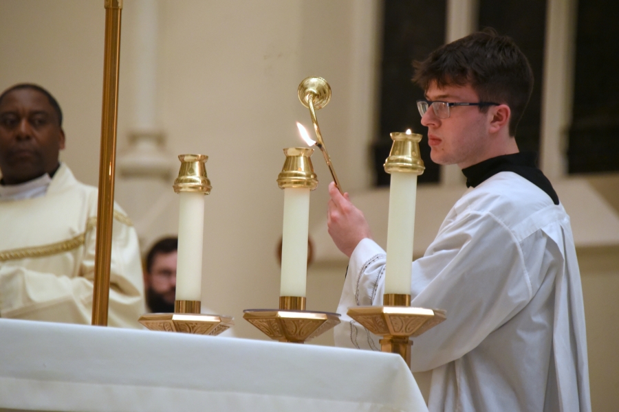 Lighting the candles on the altar.