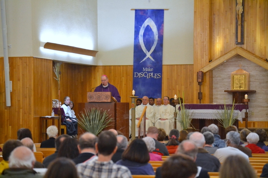 Bishop Deeley delivers his homily as parishioners look on.