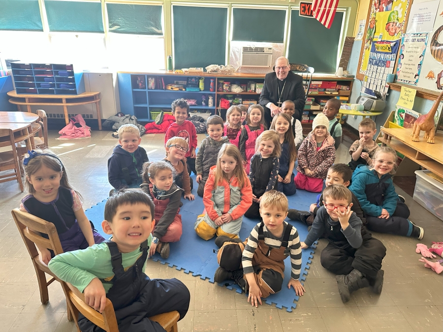 Bishop with group of students in classroom