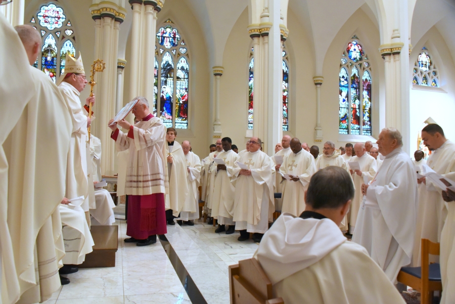 Bishop Deeley and priests as they renew their promises.