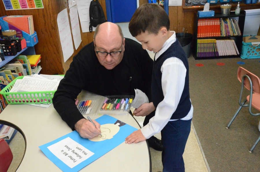 priest drawing with student 