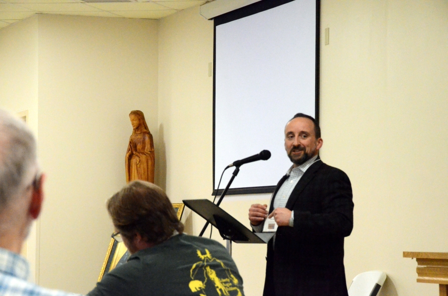 man speaking at microphone