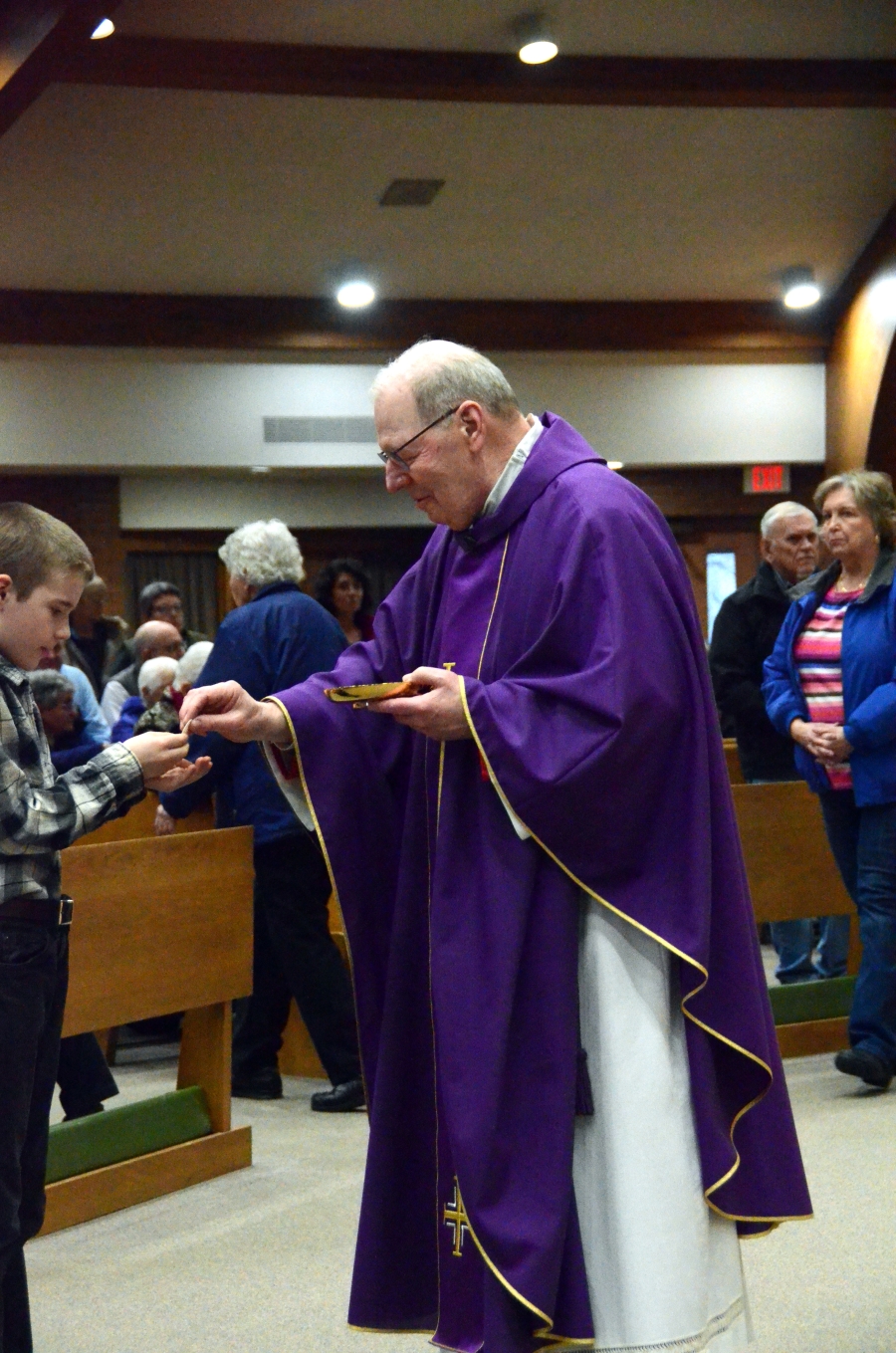 Priest giving communion