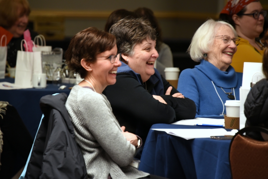 Three women laughing.