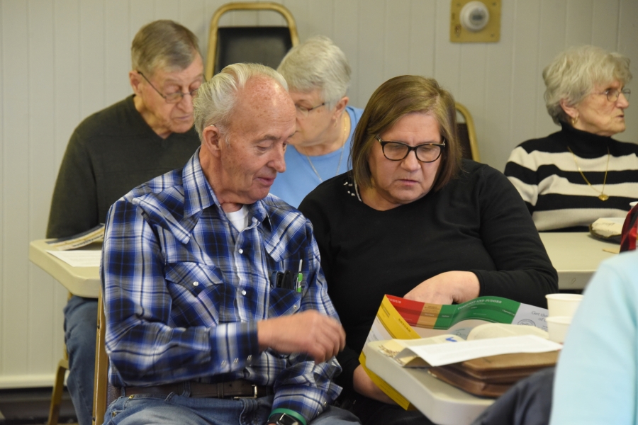 A man and a woman read from Scripture.