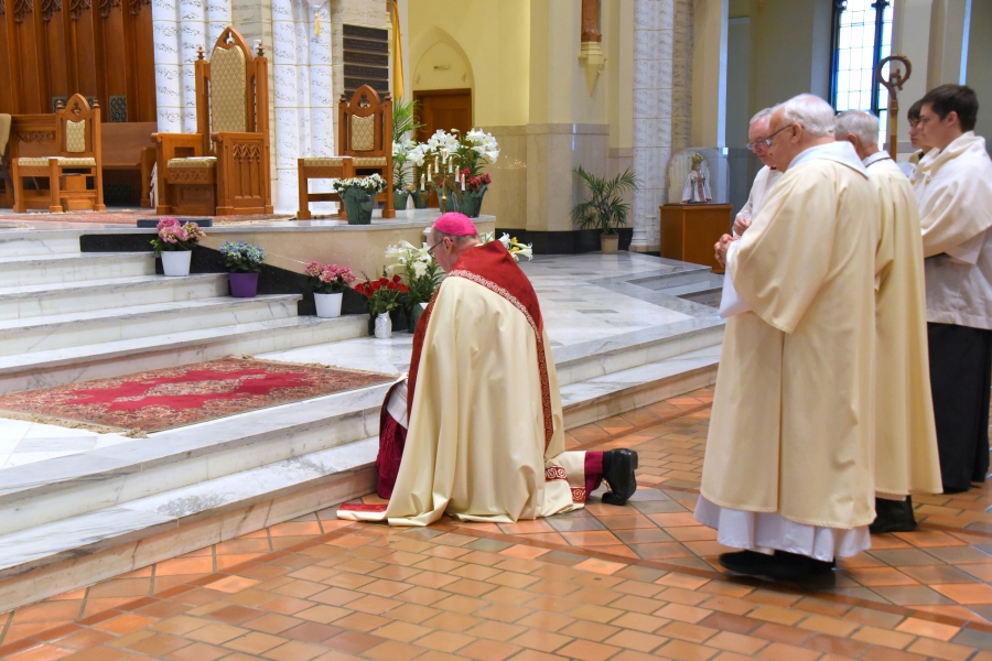 Bishop Deeley genuflects before the altar.