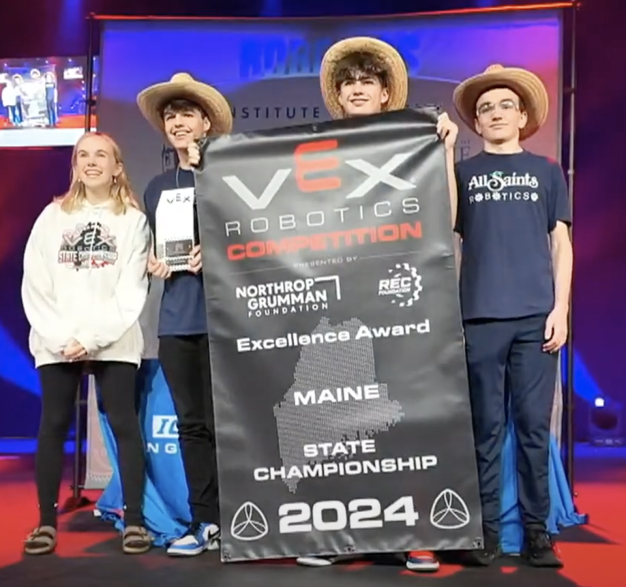 students with banner from winning robotics competition