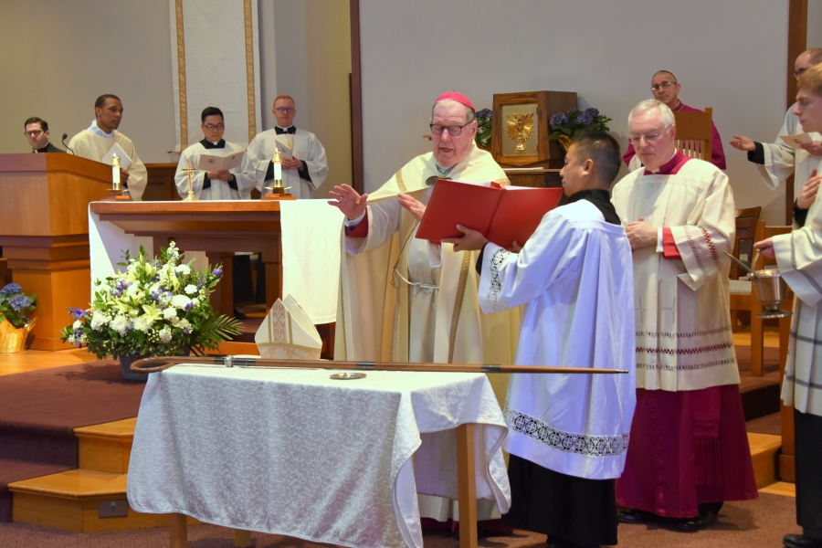 Bishop Robert Deeley blesses the ring, miter, and crosier.