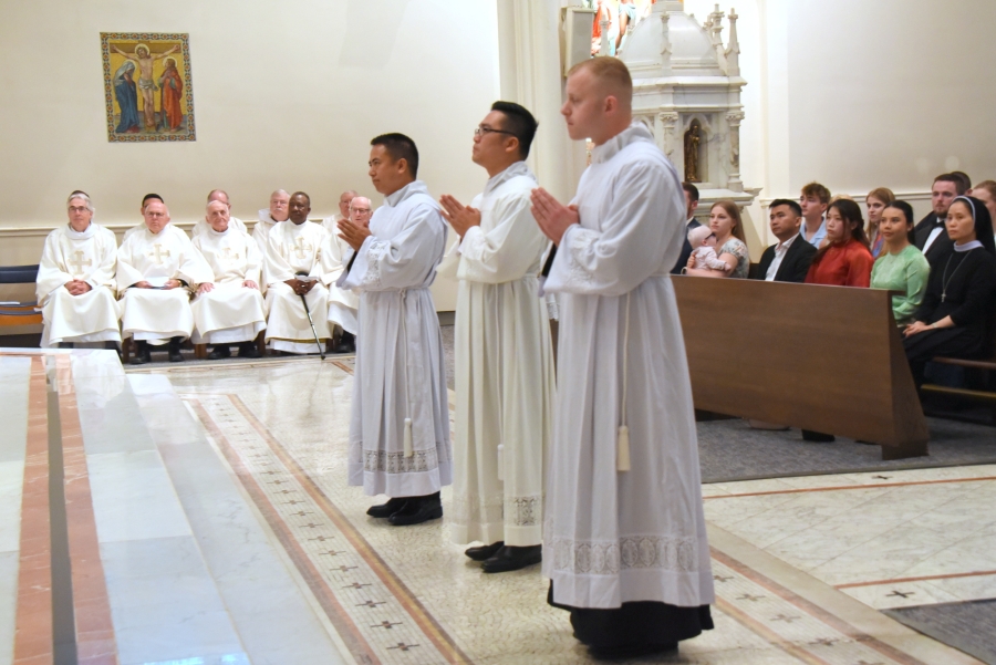 The three ordinands stand before the bishop.