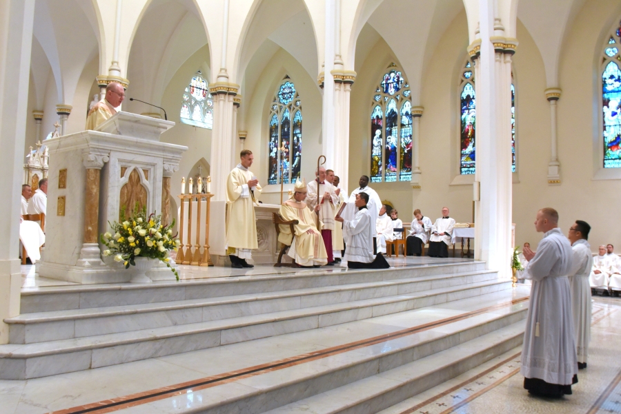 The three ordinands stand before the bishop.