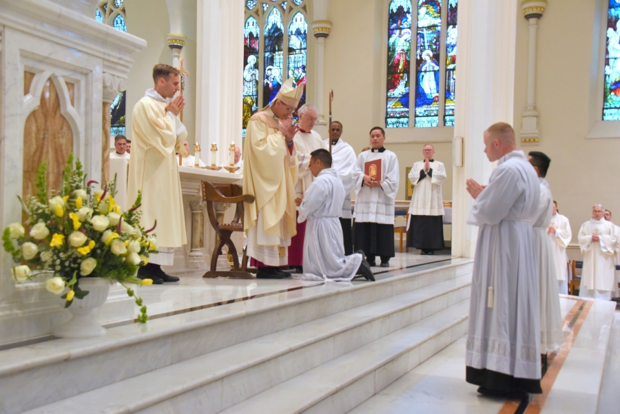 Bishop Ruggieri lays hands on Tien Hoa Nguyen