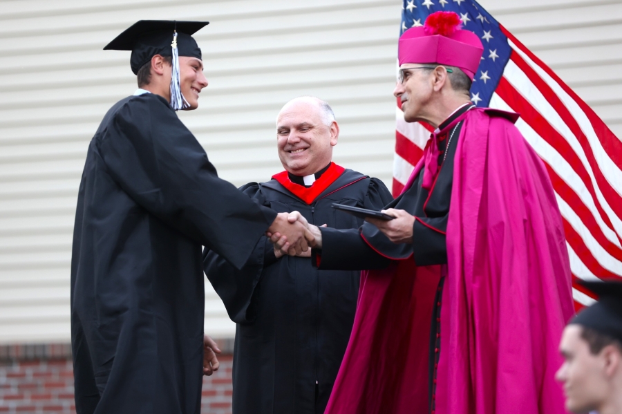 Bishop Ruggieri handing out diplomas