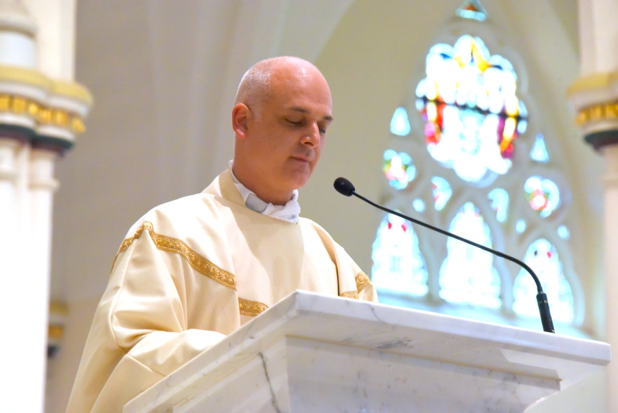 Father Seamus Griesbach reads the Gospel.