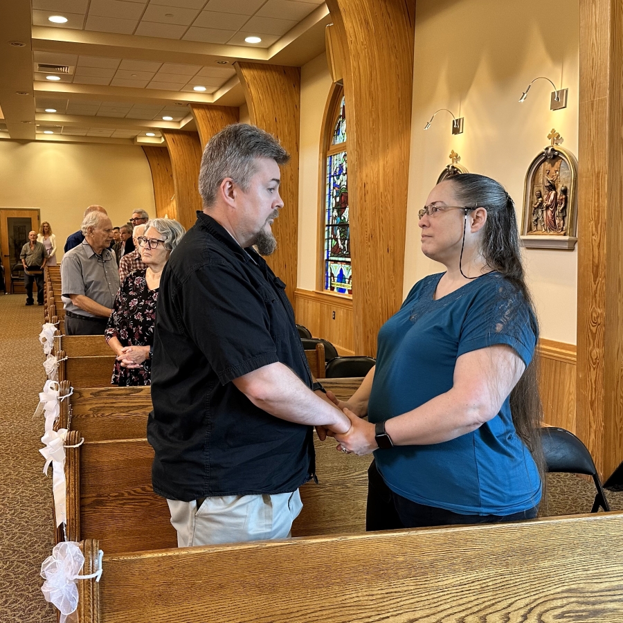 couple holding hands in church 