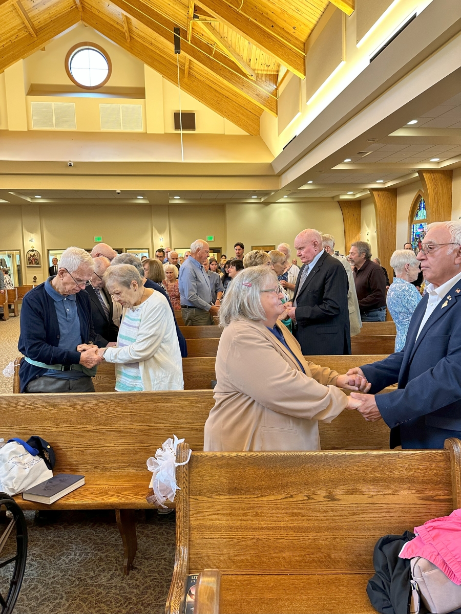 couples holding hands in church 