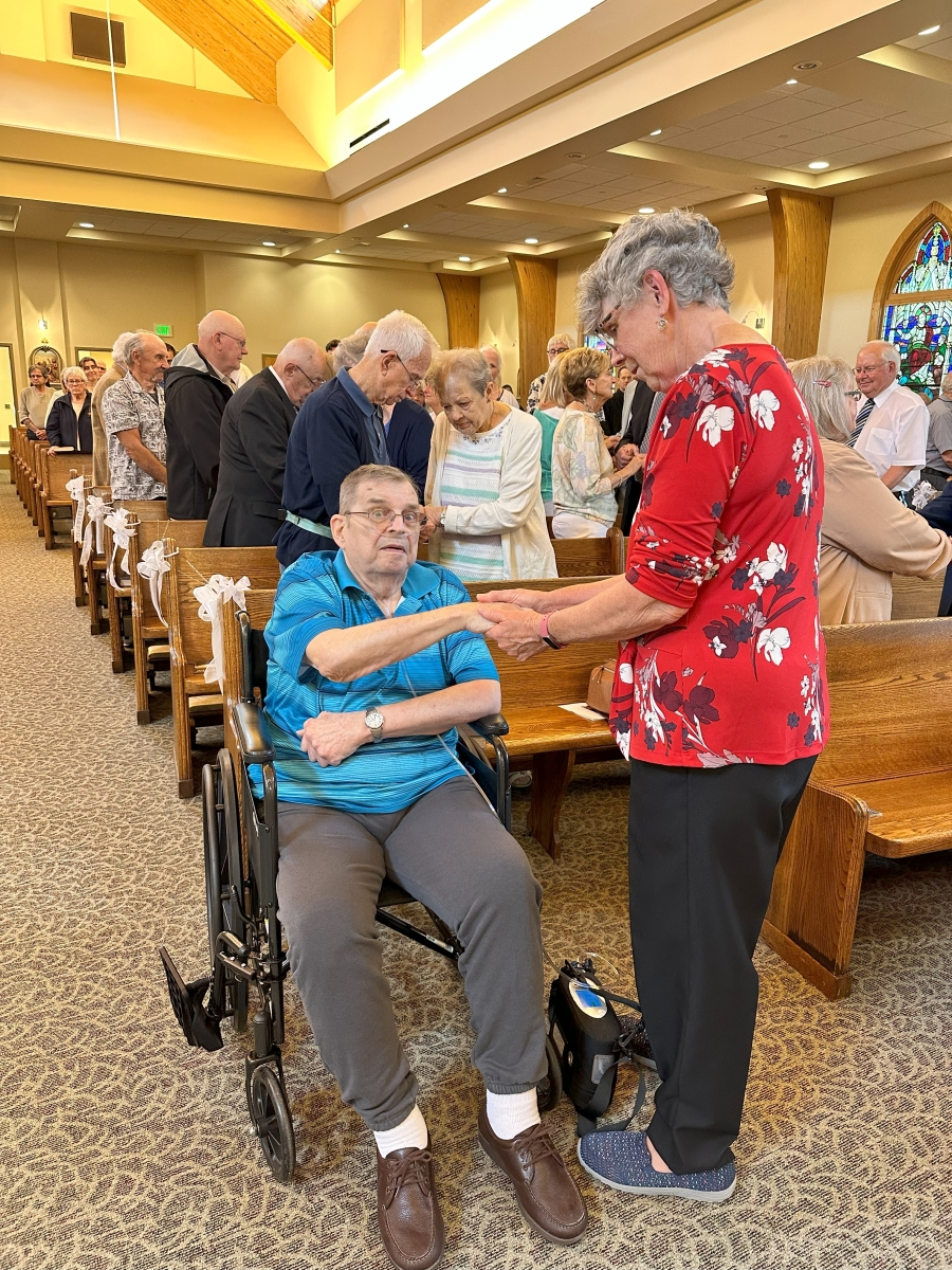 couple holding hands in church 