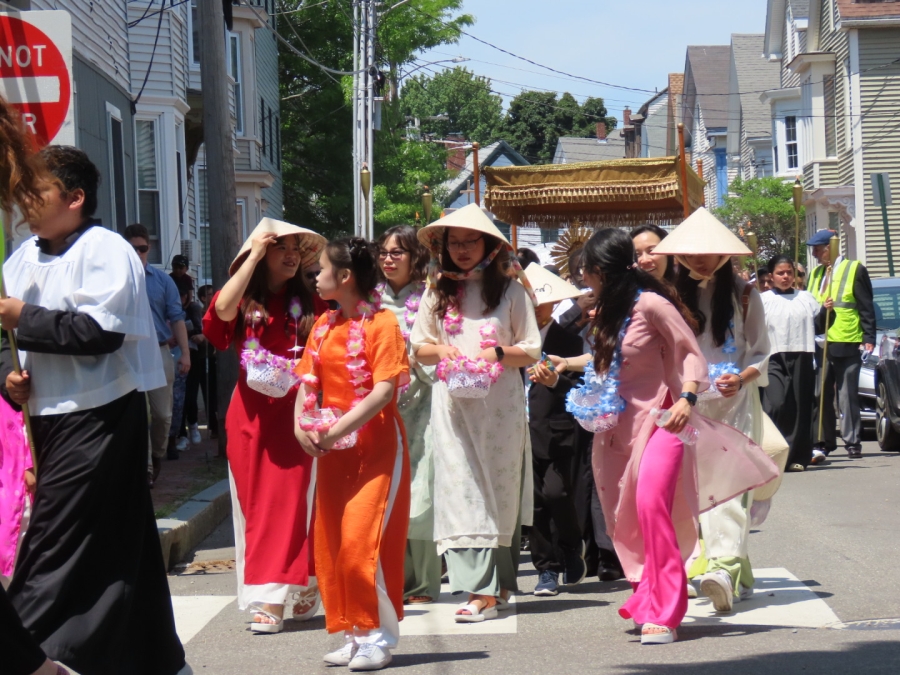 people walking in the street for the Feast of Corpus Christi Procession