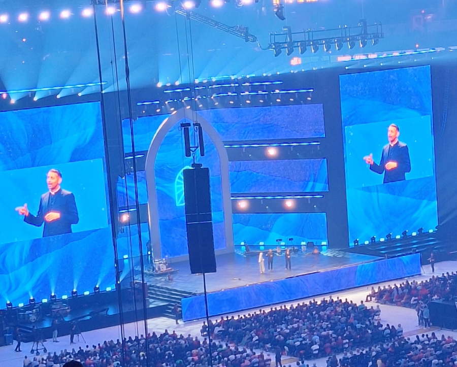 the stage with a speaker at the 10th National Eucharistic Congress