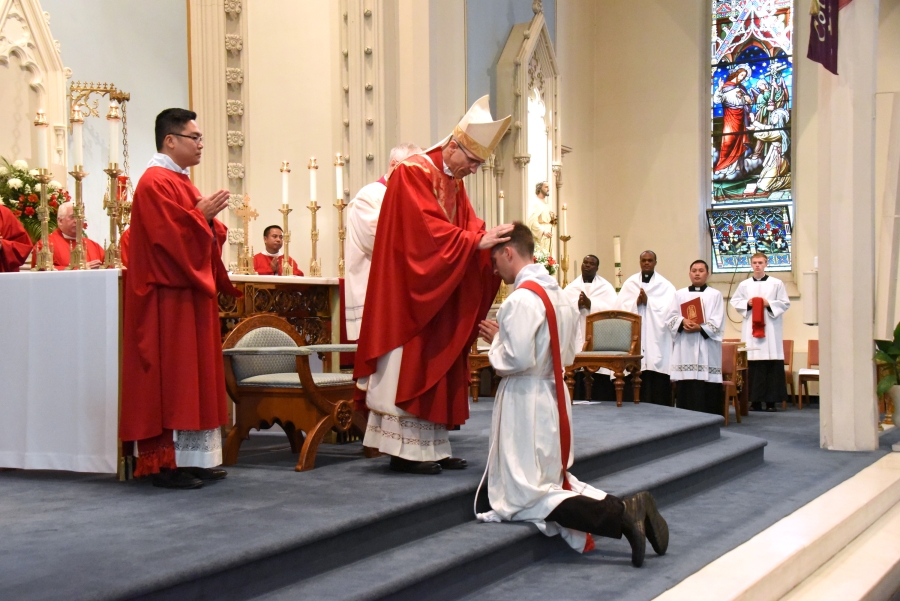 Bishop Ruggieri lays hands on Deacon Matthew Valles.