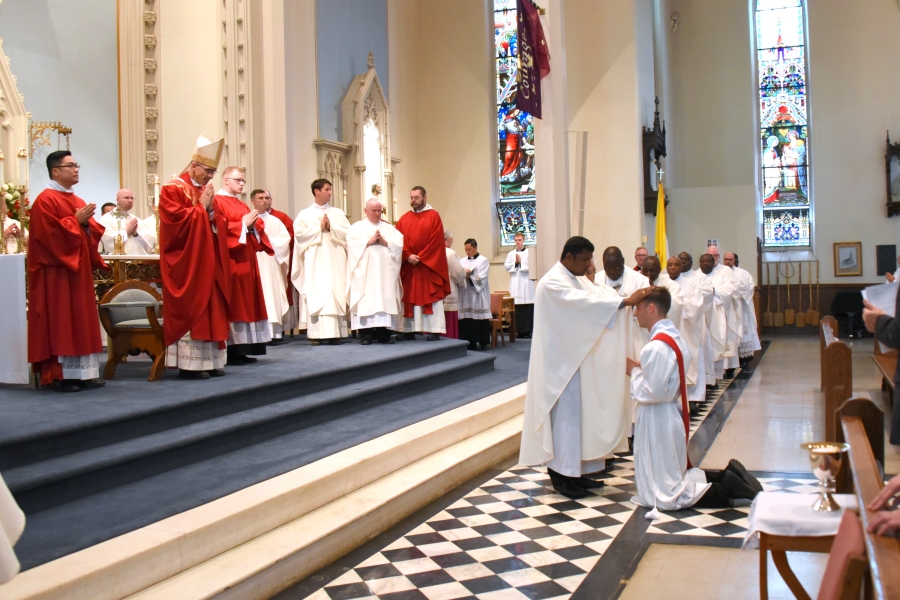 Father Agustin Sebasthiyan lays hands on Deacon Matthew Valles.