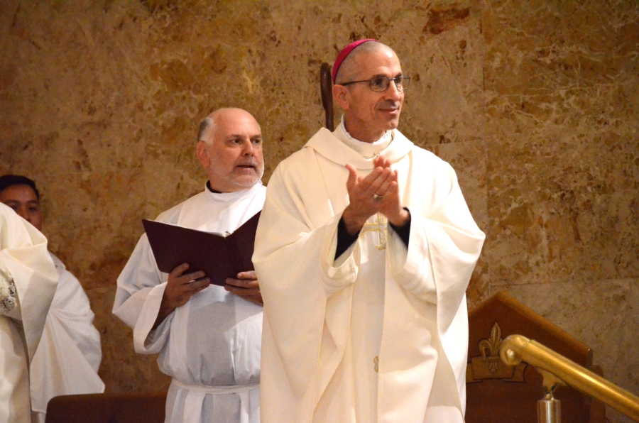 Bishop clapping on the altar