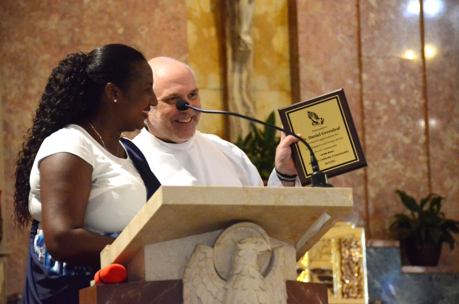 Woman presenting plaque to priest