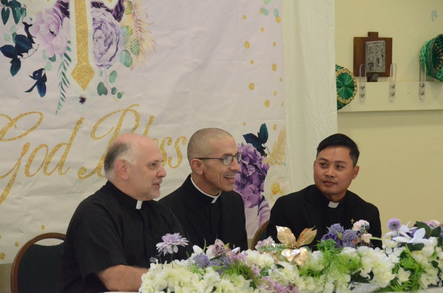 Three priests seated at table