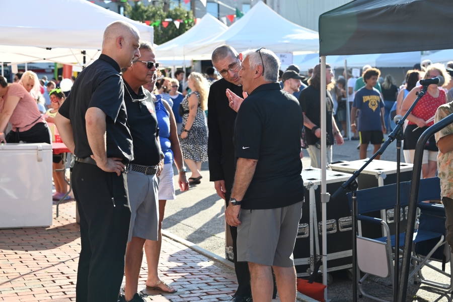 Father Seamus Griesbach and Bishop Ruggeri chat with a gentleman.