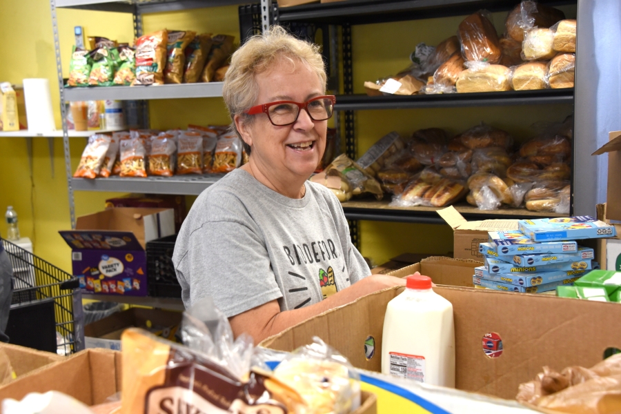 Biddeford Food Pantry Volunteer packing a box.