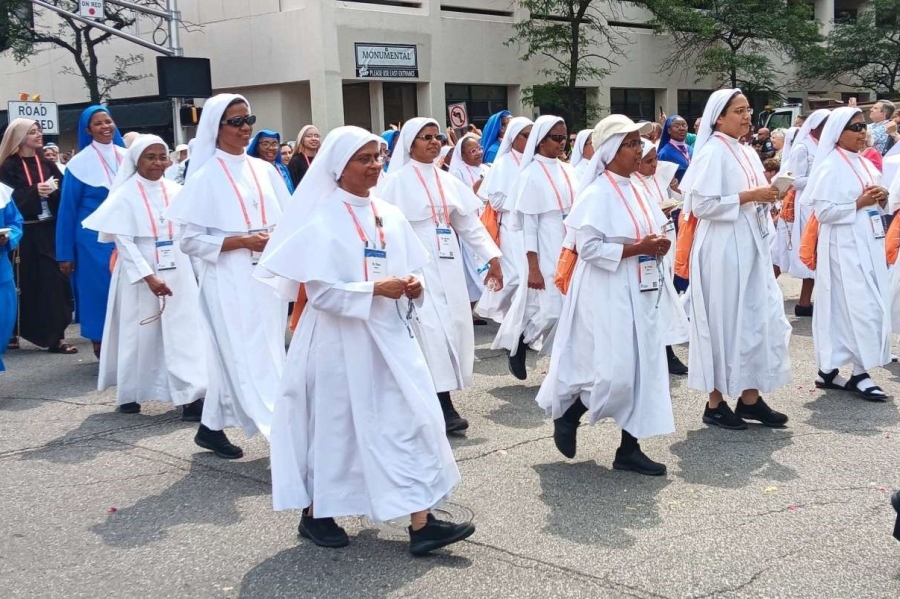 Women religious walk in the eucharistic procession.