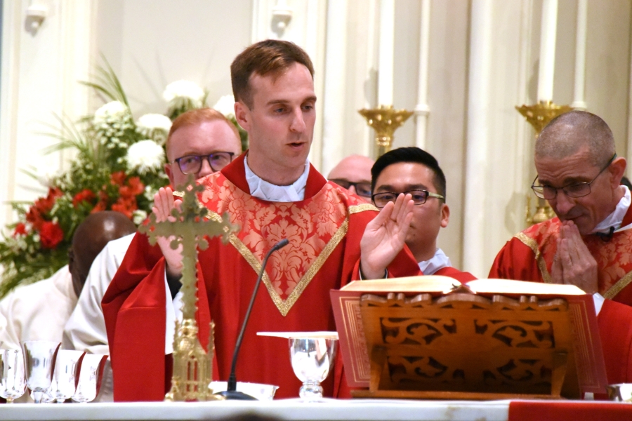 Father Matthew Valles reads part of the eucharistic prayer.